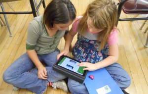 Students in the classroom with an iPad
