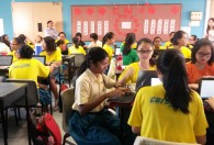 Students at Crescent Girls School in Singapore discuss conflict and discrimination in groups while working on a shared Google Doc.